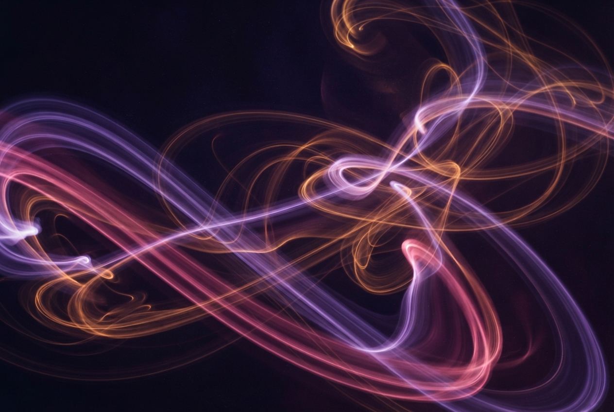 Abstract glowing purple, pink, and orange light trails curling across a dark background.